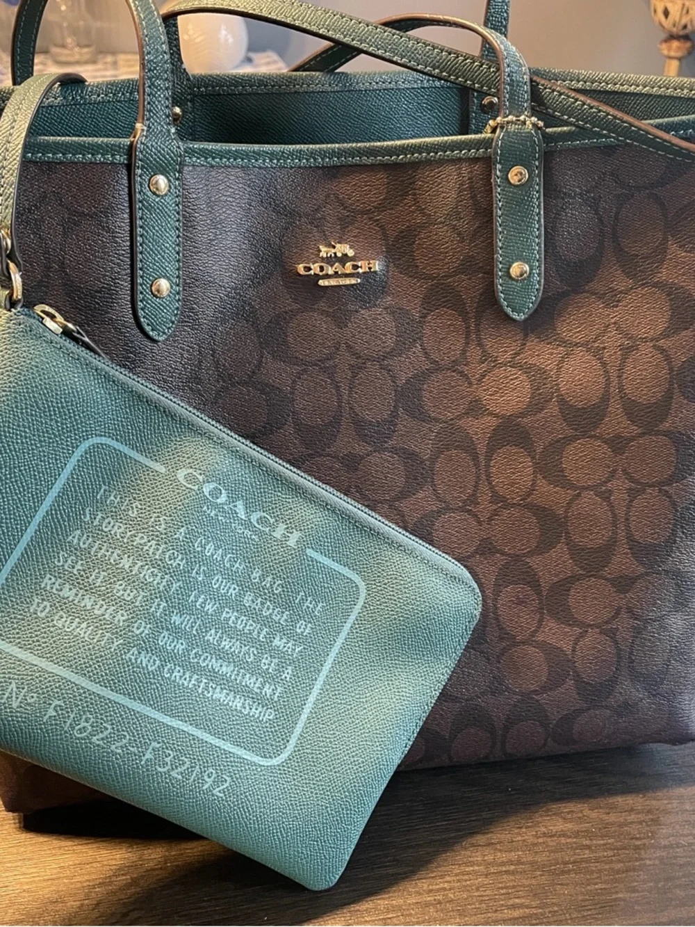 Coach Classic Brown Signature Canvas ReversibleTote with Teal Wristlet.
